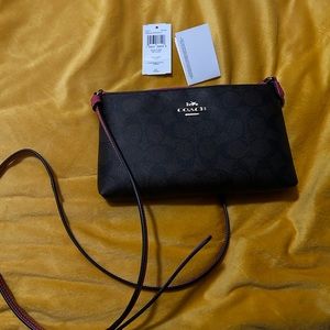 Brown coach purse with pink trim